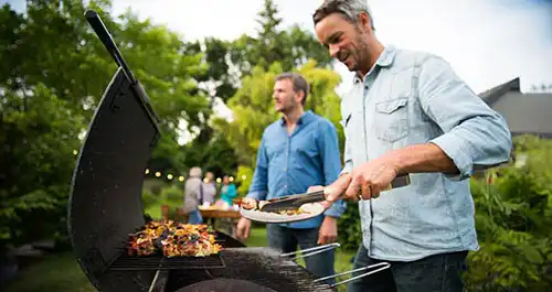 People grilling in the backyard in summer