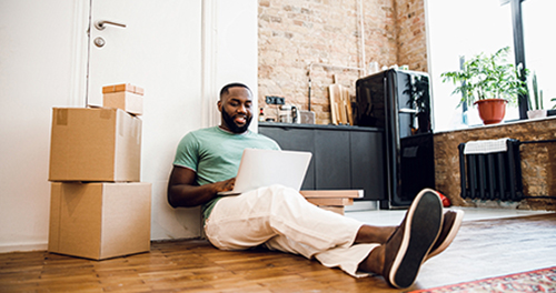 Confident man with laptop working at home stock photo