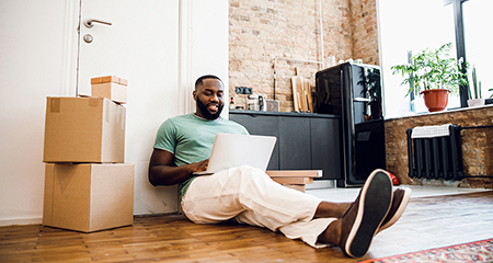 Confident man with laptop working at home stock photo