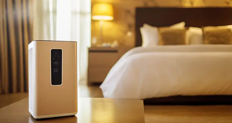 Air purifier dehumidifier in a cozy bedroom