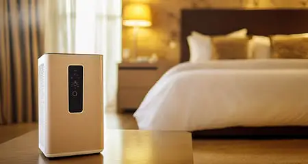 Air purifier dehumidifier in a cozy bedroom