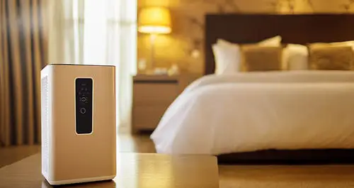 Air purifier dehumidifier in a cozy bedroom