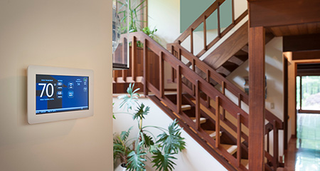 Photo of a smart thermostat on a wall inside a home